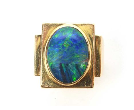 An opal ring, the black coloured oval opal cabochon, probably a doublet, measuring approximately16 x 12.4mm, within collet mo