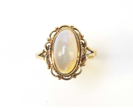 An opal ring, the oval opal cabochon measuring approximately 14.8 x 8.5 x 4.7mm, in a shaped oval and beadwork mount, the yel