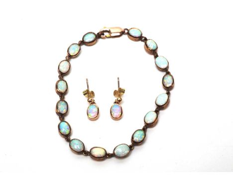 A Gilson synthetic opal bracelet and drop earrings, the 9ct. gilt and synthetic opal bracelet set with sixteen links set with