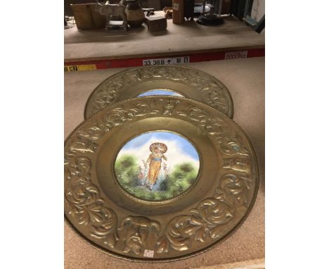 A PAIR OF VINTAGE BRASS CIRCULAR PLAQUES WITH INSET CERAMIC CENTRES 