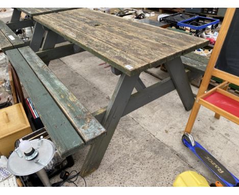 A WOODEN PICNIC BENCH 