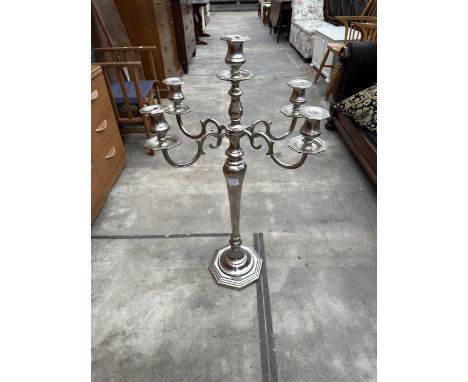A FOUR BRANCH POLISHED METAL CANDELABRA WITH CENTRAL CANDLESTICK, 20" WIDE AND 38.5" HIGH 