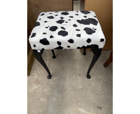 A MODERN STOOL ON CABRIOLE LEGS WITH COW PRINT COVER 