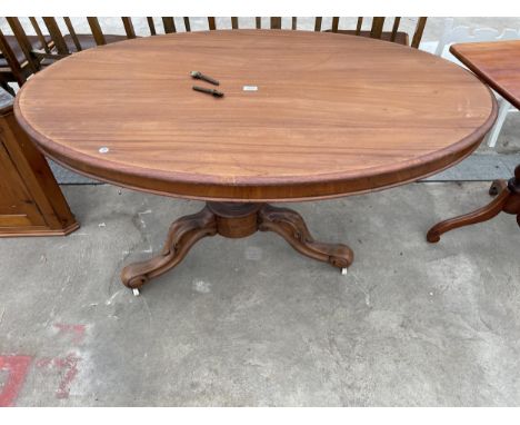 AN OVAL VICTORIAN TILT-TOP LOO TABLE ON TRIPOD BASE, WITH PORCELAIN CASTERS, 54 X 38" 