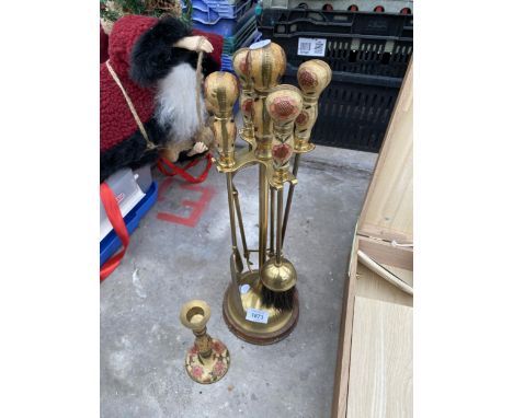 A BRASS COMPANION SET AND A BRASS CANDLESTICK 