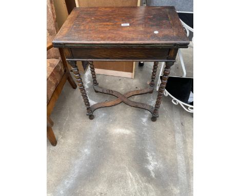 AN EARLY 20TH CENTURY OAK FOLD-OVER GAMES TABLE ON BOBBIN TURNED LEGS WITH X-FRAME STRETCHERS, 24 X 16" 