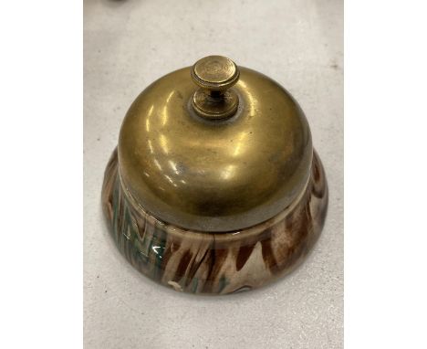 A VINTAGE BRASS AND POTTERY DESK BELL 