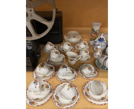 A VINTAGE PALISSY TEASET WITH FLORAL PATTERN ON A CREAM BACKGROUND TO INCLUDE CAKE PLATES, SUGAR BOWL, CREAM JUG, CUPS, SAUCE