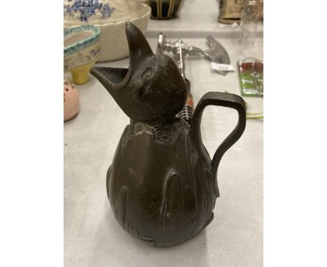 A VINTAGE METAL JUG DESIGNED AS A BIRD HATCHING, STAMPED TO BASE 