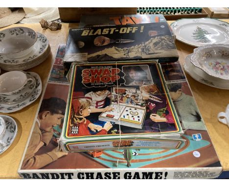 FOUR VINTAGE BOARD GAMES TO INCLUDE 'BANDIT CHASE GAME', MULTI-COLOURED SWAP SHOP, WADDINGTON'S BLAST-OFF AND TAXI 