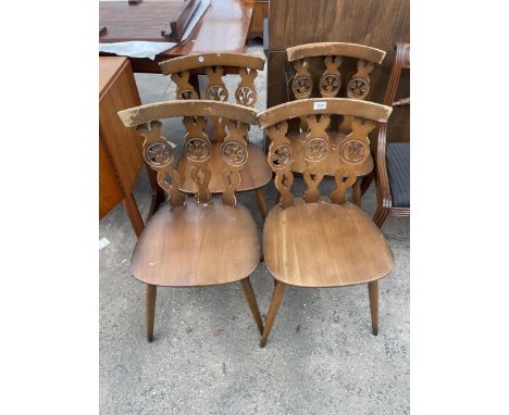 A SET OF FOUR ERCOL ELM AND BEECH FLEUR DE LYS DINING CHAIRS 