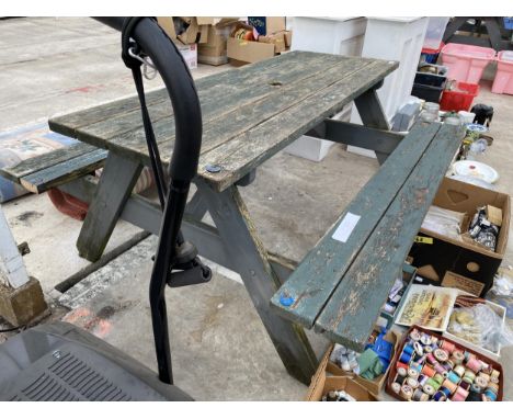 A WOODEN PICNIC BENCH 