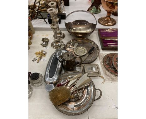 A LARGE QUANTITY OF VINTAGE SILVER PLATED ITEMS TO INCLUDE CANDLESTICKS, A GALLERIED TRAY, LARGE HANDLED BOWL, FLATWARE, SMAL