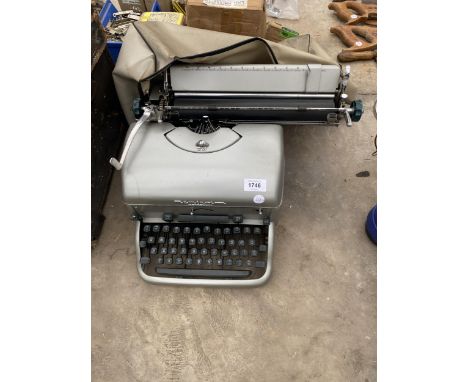 A RETRO REMINGTON TYPEWRITER WITH COVER 