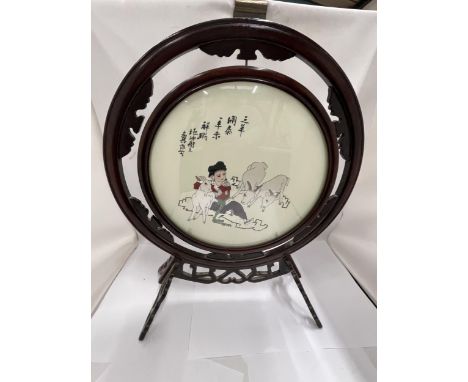 A CHINESE WOODEN FRAMED CIRCULAR PRINT OF A GIRL WITH GOATS 