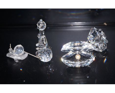 5 pieces of swarovski crystal swan, oyster and pearl, mouse, cat AF and a snail. All boxed 