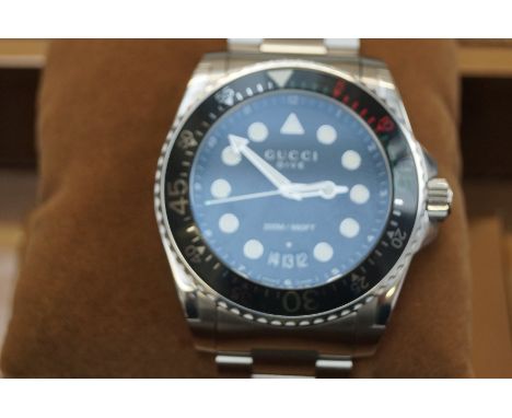 Gucci Dive calendar wristwatch with black ceramic bezel. All round very good condition .With box, outer box and papers