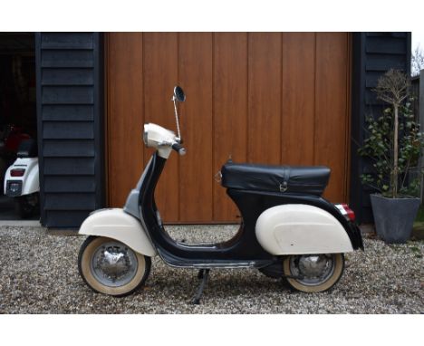 A 1975 Vespa 50 Special, registration number PWR 647P, frame number V5B3T 41911, engine number V5A2M, black/cream.  This hard