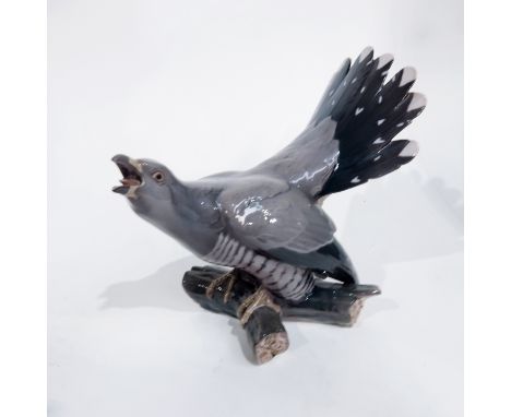 Dahl Jensen for Bing and Grondahl, a Danish porcelain figure of a cuckoo, model 1770, on branch, painted and printed marks