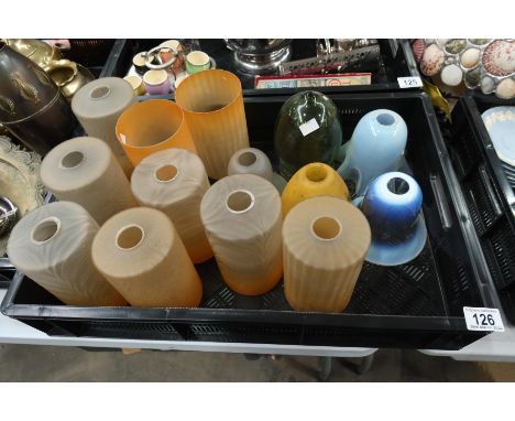 A collection of glass lamp shades including a harlequin set of Art Deco graded amber shades, a vaseline glass shade, another,