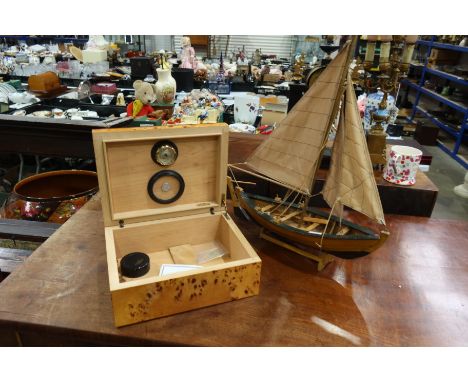 A Savinelli humidor, poplar burr veneer, width 27cm, together with a model of a sailing boat (2)