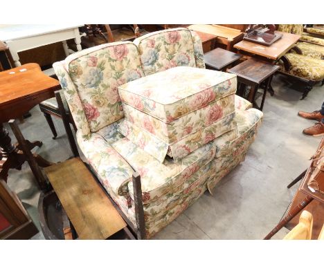 A florally upholstered two seater settee, 116cm wide and pouffe (2)