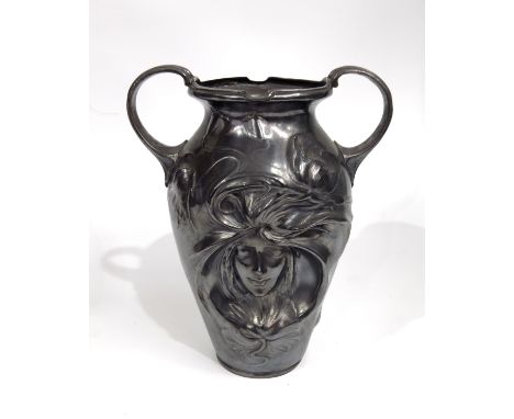 An Art Nouveau silver plated twin handled vase, shouldered form, relief moulded with the head of a sleeping maiden within sin