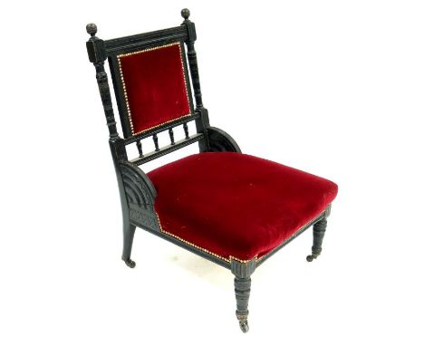 An Aesthetic Movement upholstered and ebonised chair, in the style of Bruce Talbert and Christopher Dresser, circa 1885, the 