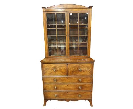 A George III mahogany strung bureau bookcase, circa 1810, arched pediment, double astragal glazed doors opening to height adj