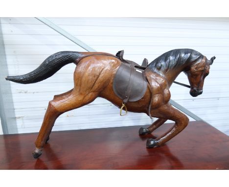 A leather bound model of a galloping horse, length 82cm long