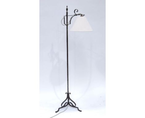 An Arts &amp; Crafts wrought iron height adjustable library floor lamp, urn finial, overhanging lamp arm, hammered finish, sc