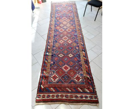 An antique Caucasian runner with Kazak design, 380 by 95cm