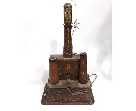 An early 20th century carved oak novelty table lamp, in the form of Kinnaird Castle Lighthouse, lighthouse body painted with 