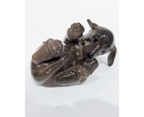 A Royal Copenhagen figure of a dachshund puppy, model 1408, in recumbent playful pose, printed and painted marks
