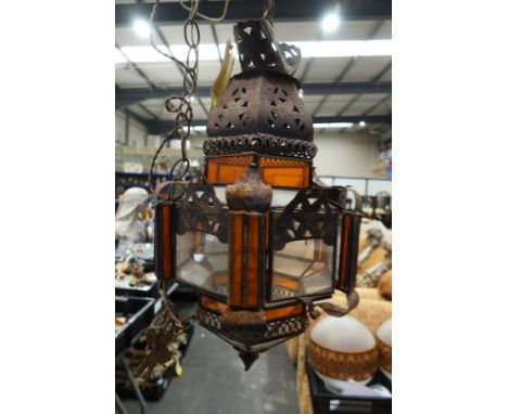 A metal and glass pendant lantern light fitting in the Moorish style