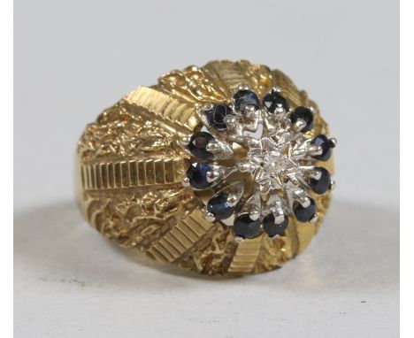 A ladies 9ct gold and signet ring set with sapphire halo and a diamond to the centre with stepped and bark effect shoulders, 