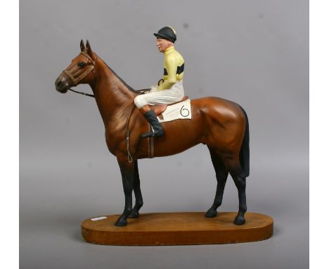 A Beswick model of Arkle and Jockey Pat Taffe designed by Author Gredington mounted on a oval hardwood plinth.