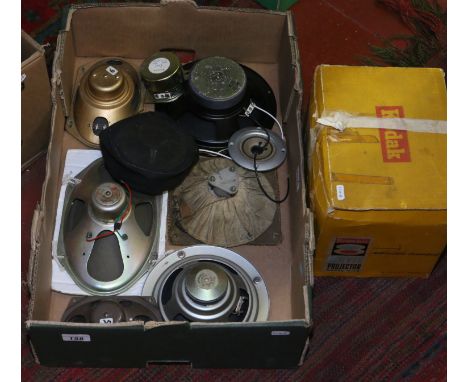 A box of various speakers, along with a Kodak movie projector.