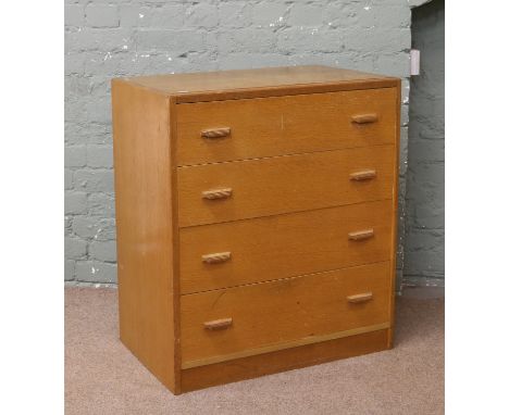 A light oak four drawer chest.