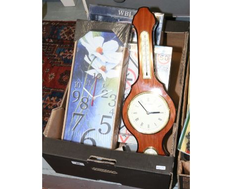 A box of wall clocks, alarm clocks and a barometer.