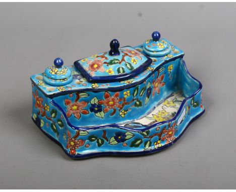 A French Longwy Faience desk stand, turquoise ground and decorated with flowers.