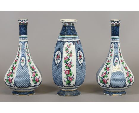 A garniture of three Losel ware vases of octagonal form decorated with prunus blossom and scale panels.