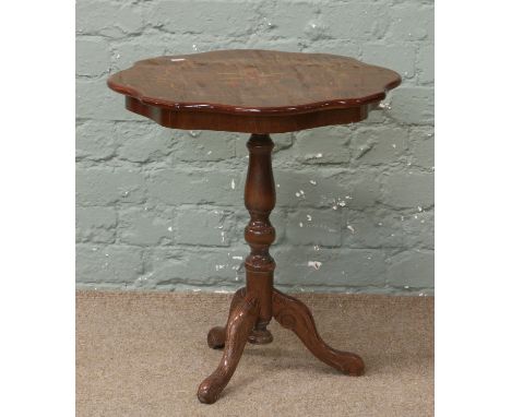 An inlaid tripod wine table.