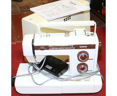 A cased Brother electric convertible sewing machine with pedal and instruction manual.
