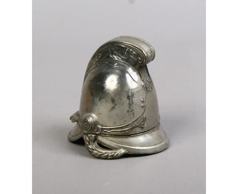 A novelty inkwell formed as a firemans helmet.