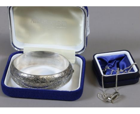 A Victorian silver bangle engraved with ivy leaves and a diamond set sterling silver pendant on chain.   Condition Report. To