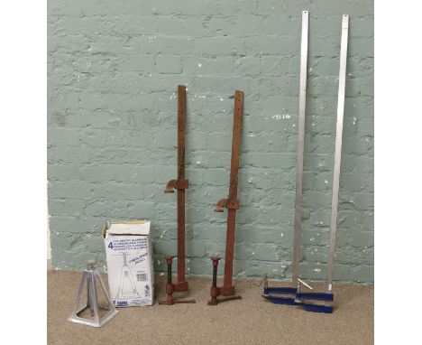 Four car jacks along with four sash clamps.