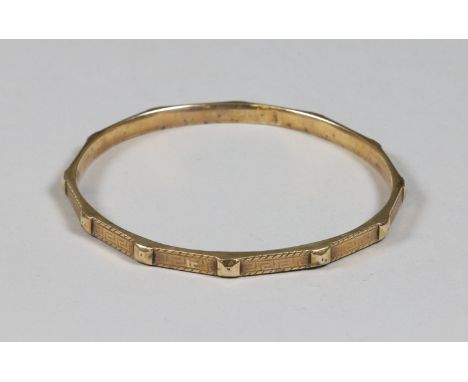 A Victorian 9ct gold bangle engraved with a Greek key design, assayed Birmingham 1849, weight 15 grams.