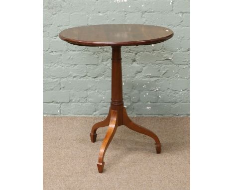 A mahogany tripod table raised on spade foot legs.