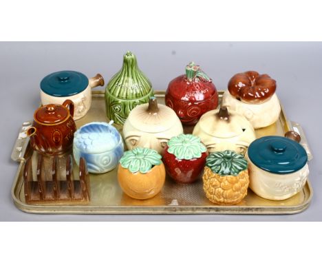 A tray of Sylvac condiment and storage pots to include face pots and Carlton ware five bar toast rack formed as a loaf of bre